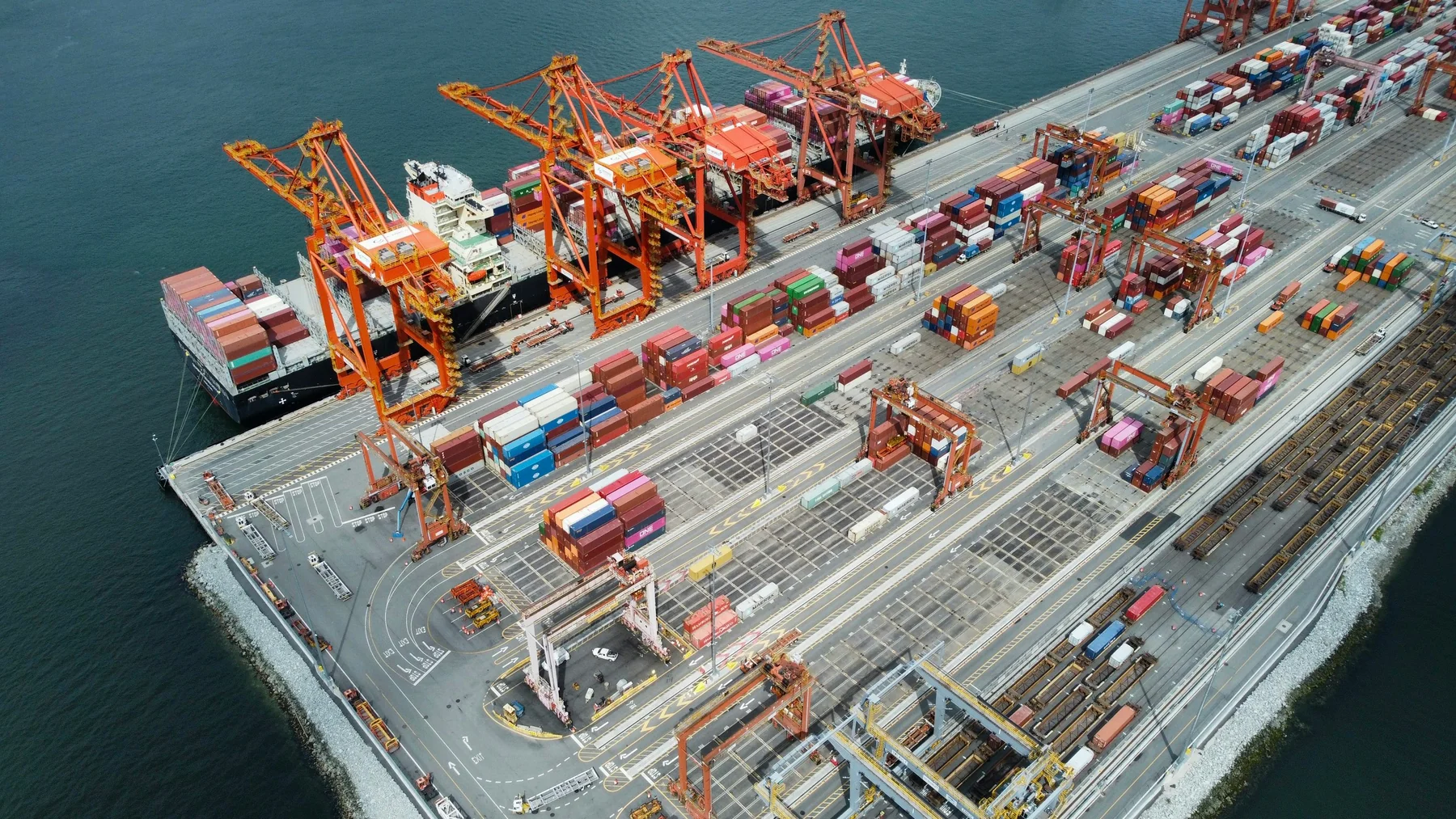 Container ship, cargo cranes and shipping containers at the Port of Vancouver.
