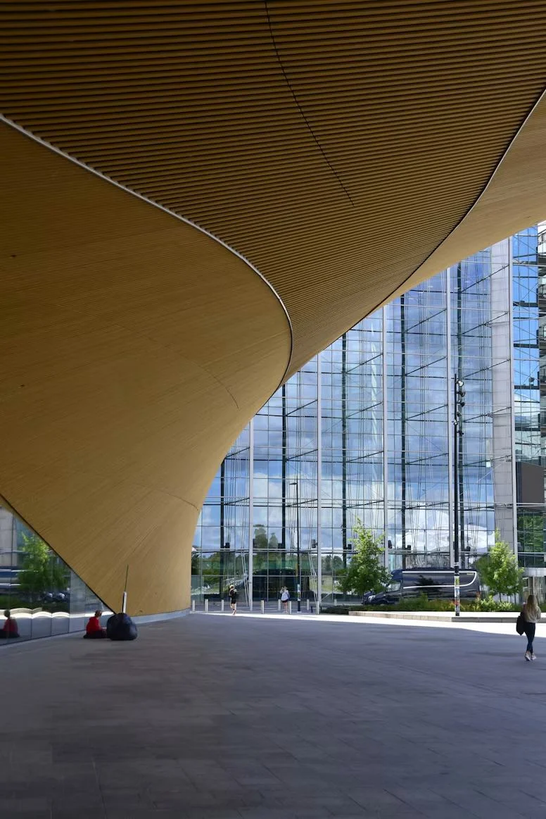 Public building with a curved wooden canopy.
