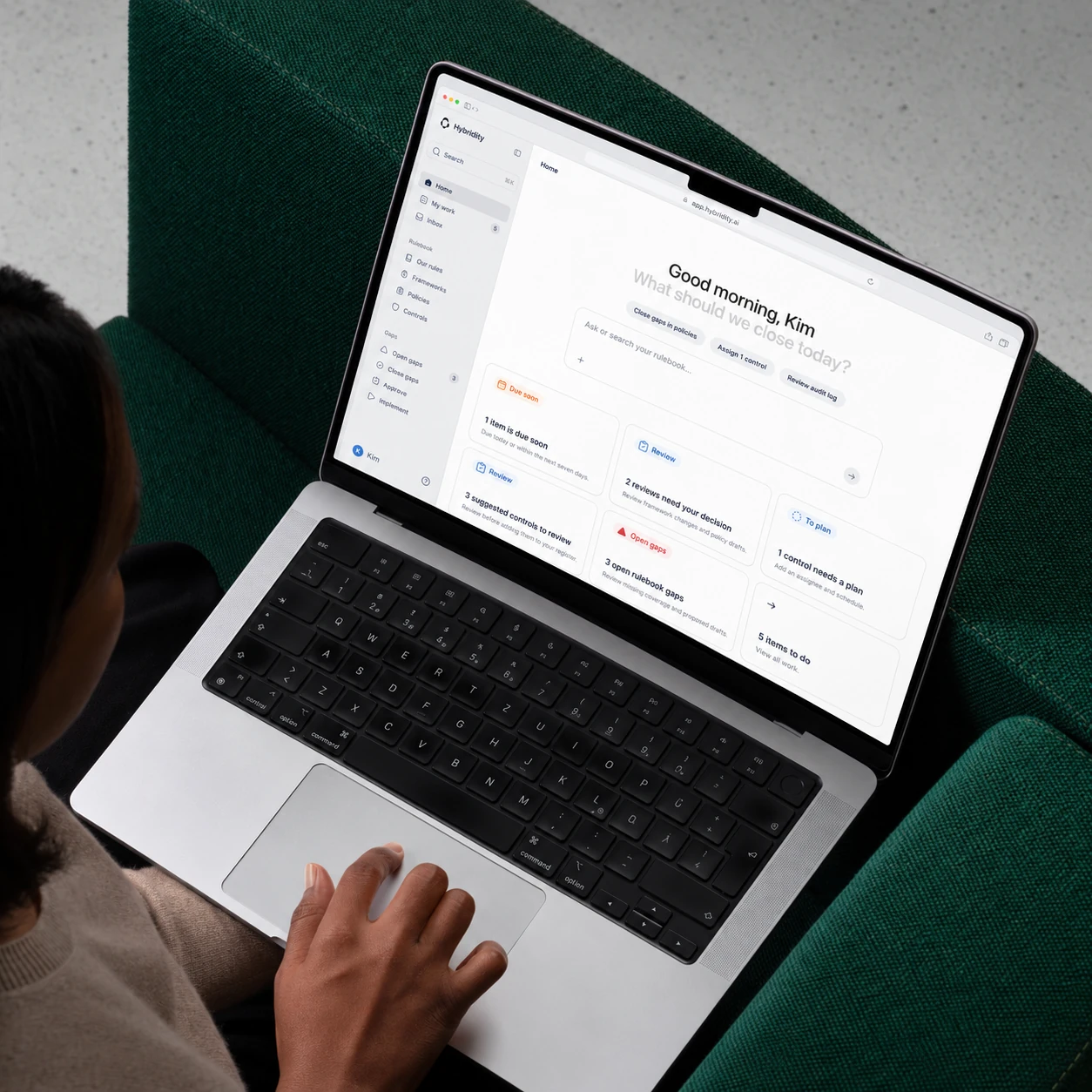Hybridity Home on a MacBook used on a green sofa.